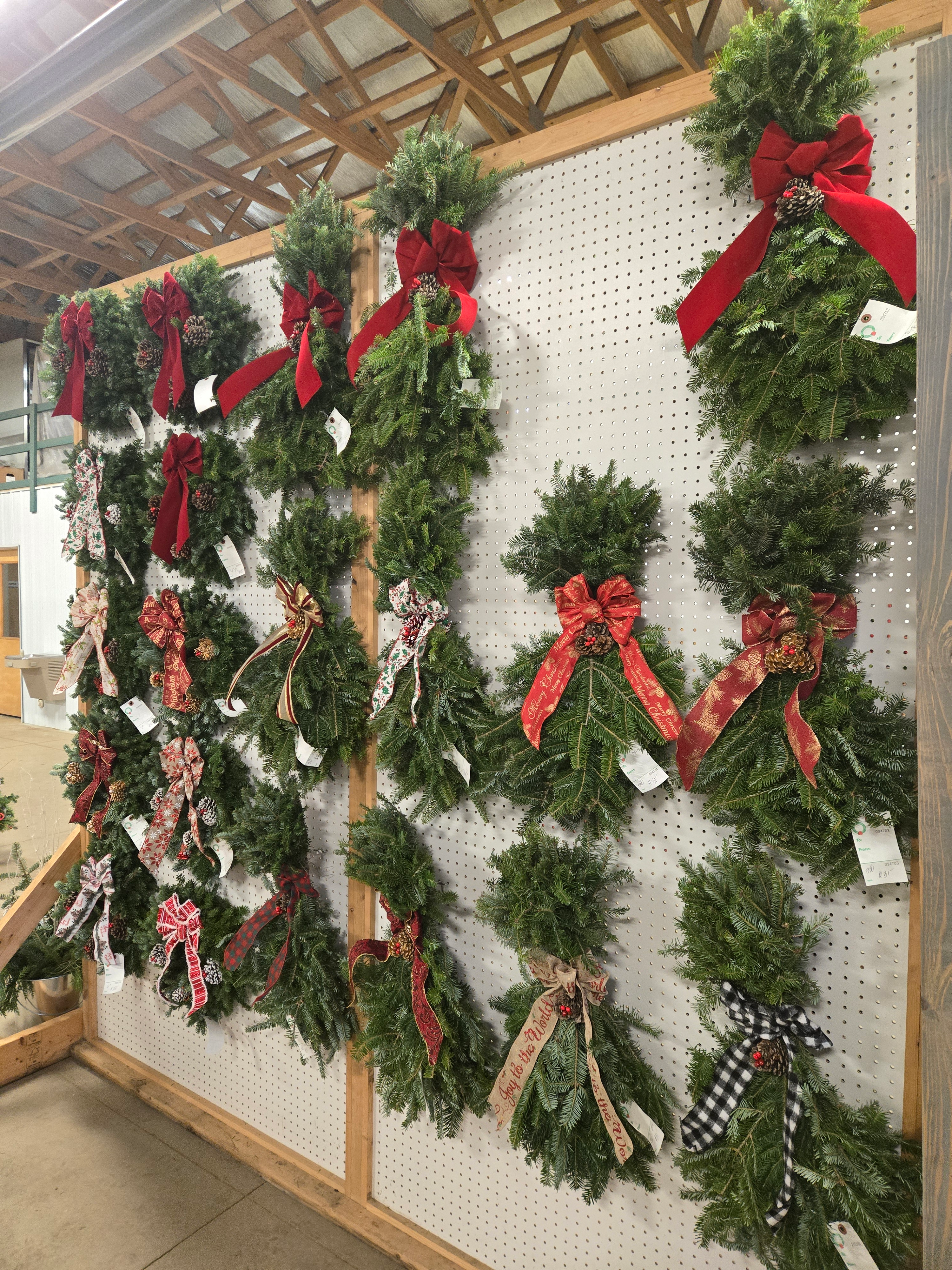 Wreaths and swags for sale at a garden center.